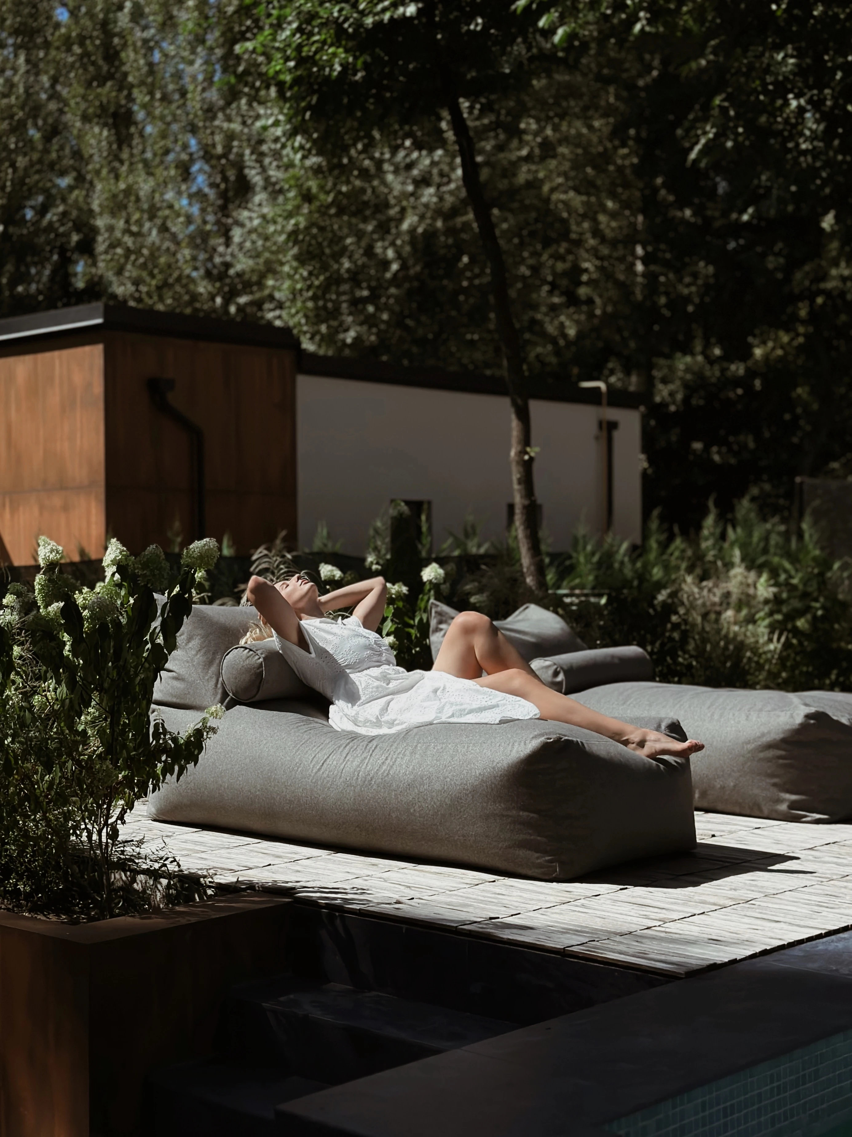 Woman reclining on a Marolla lounger poolside