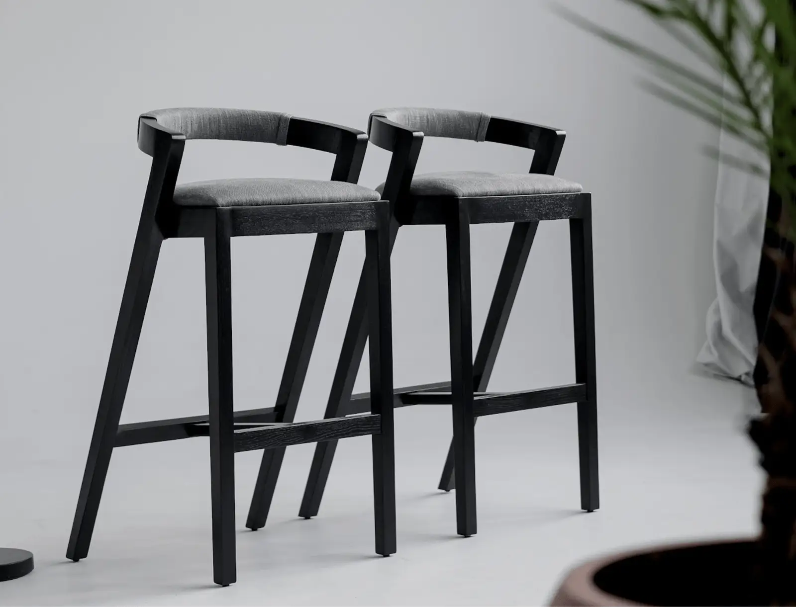 Two Baffi bar stools photographed in a clean studio on white floor