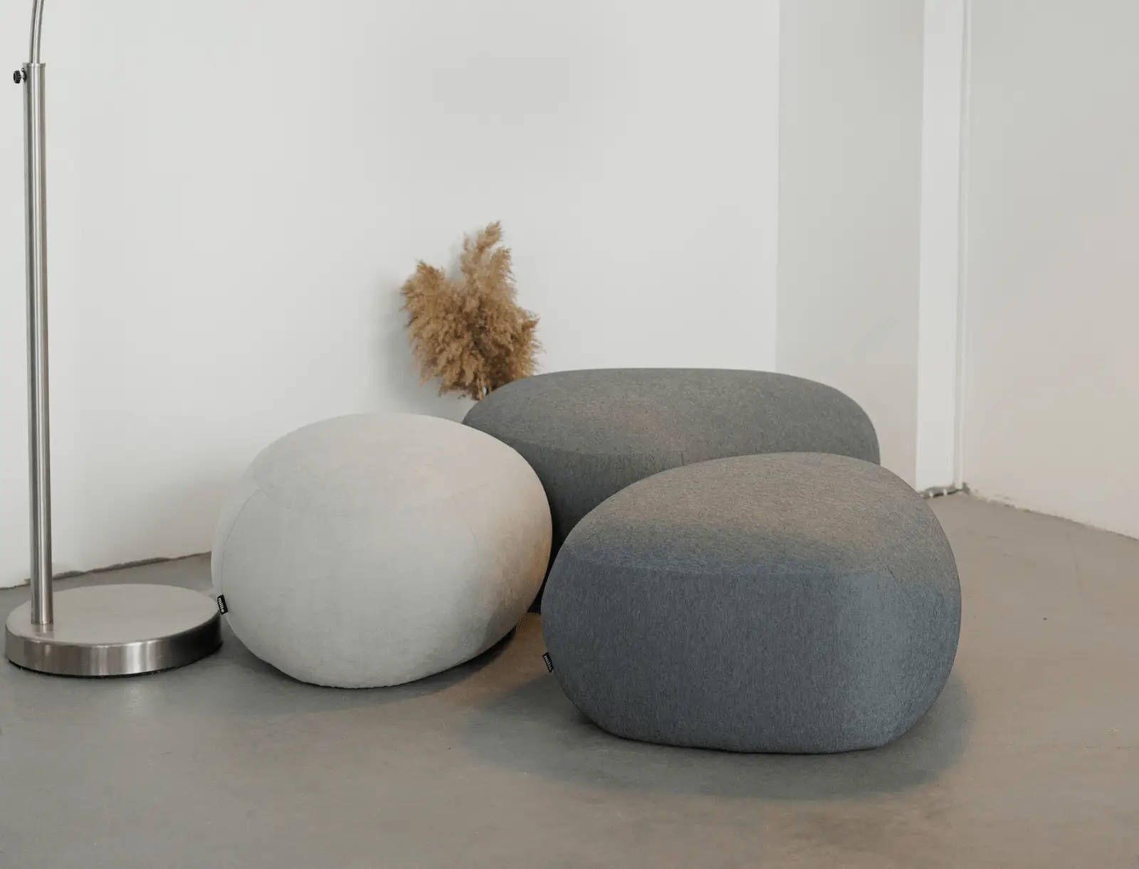 Four Chios poufs in Glasgow weave on a cement studio floor with pampas