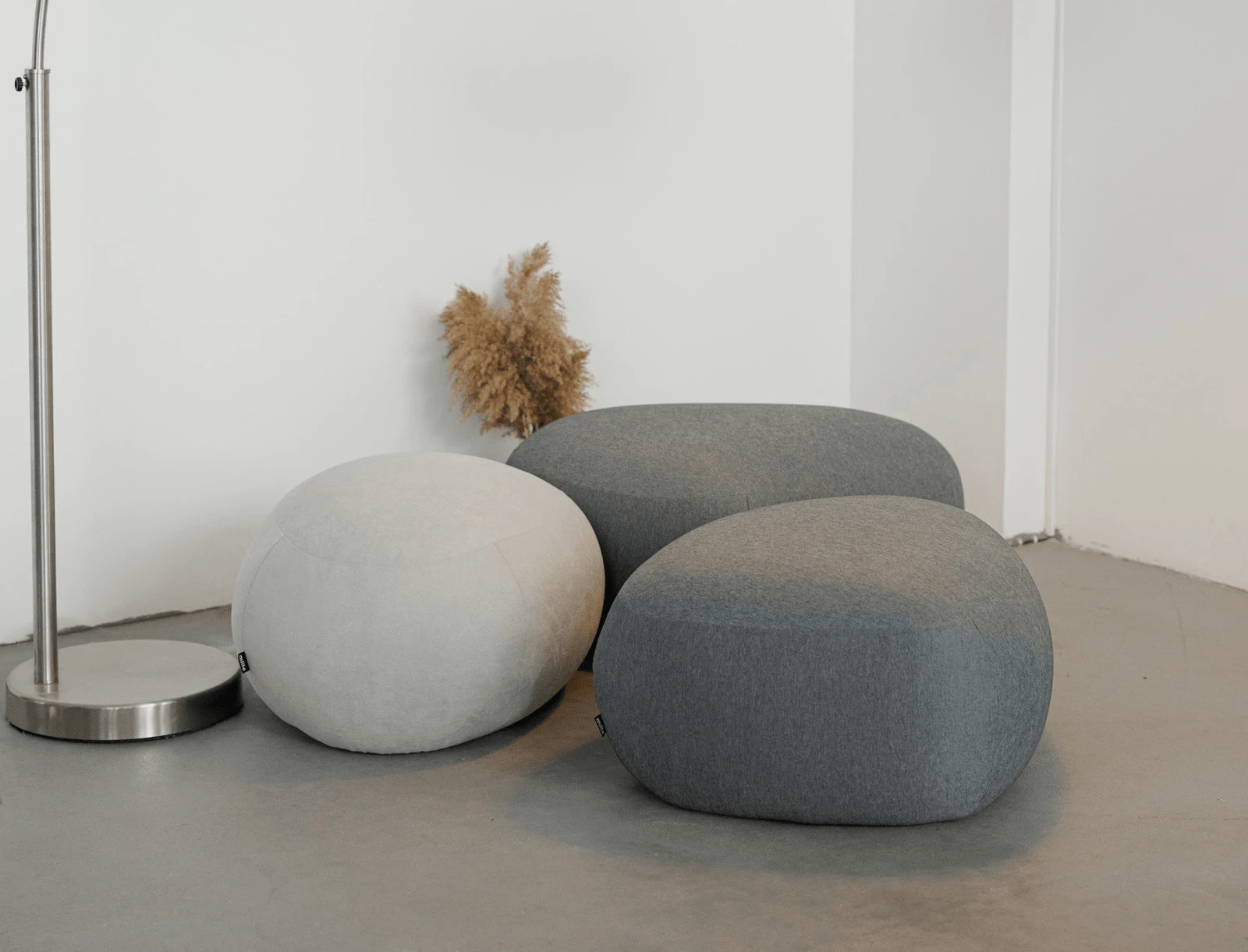 Four Chios poufs in Glasgow weave on a cement studio floor with pampas