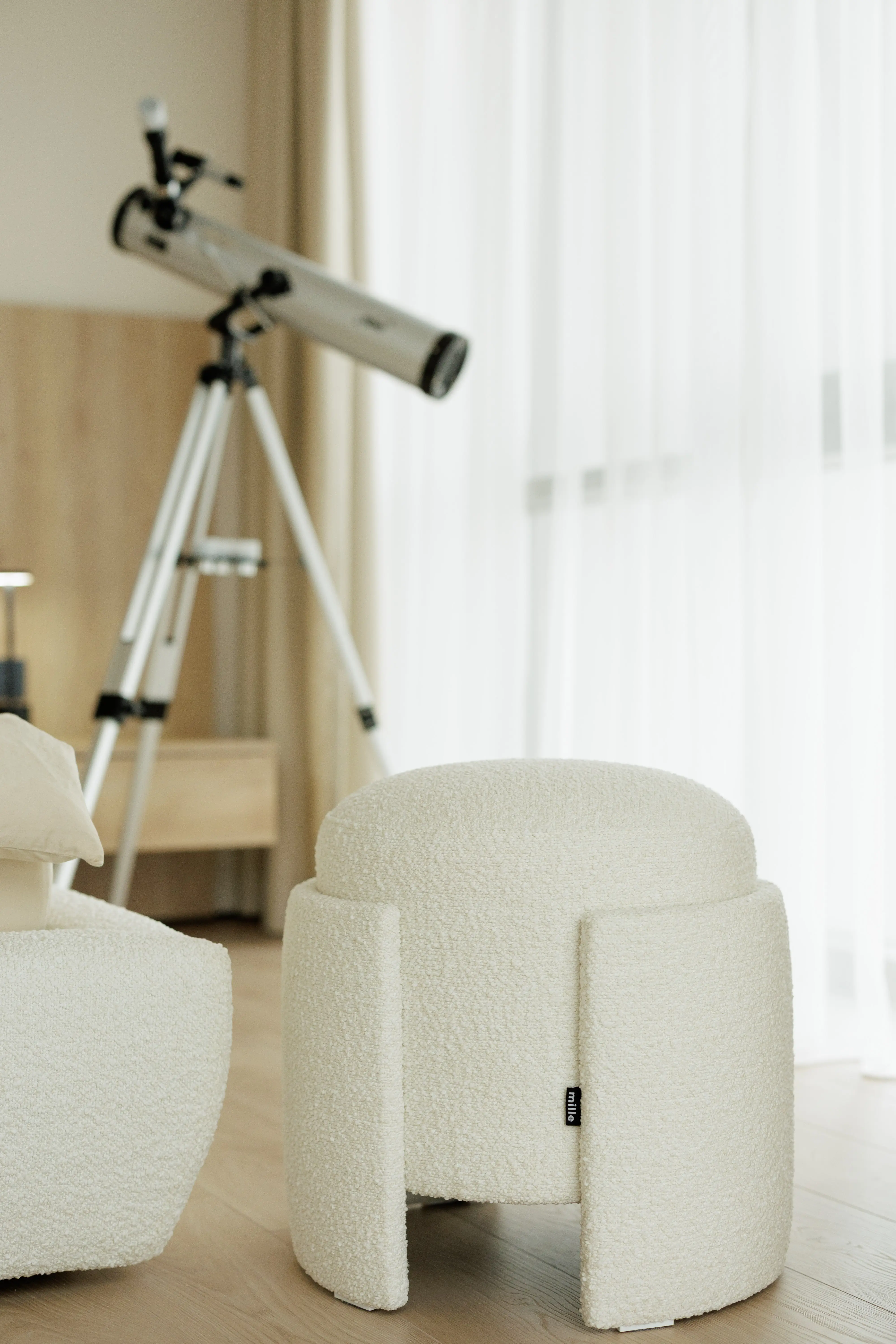 Eden pouf beside a telescope in a sunlit bedroom