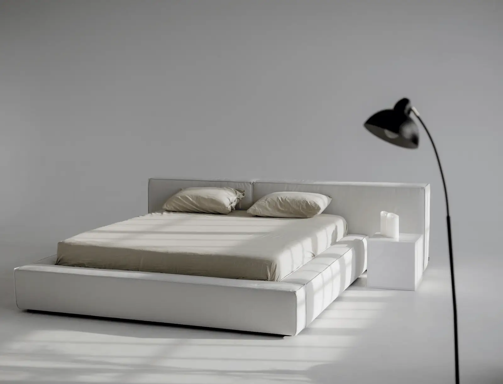 Cream Palermo in a clean studio with a black floor lamp on the right and a small side surface