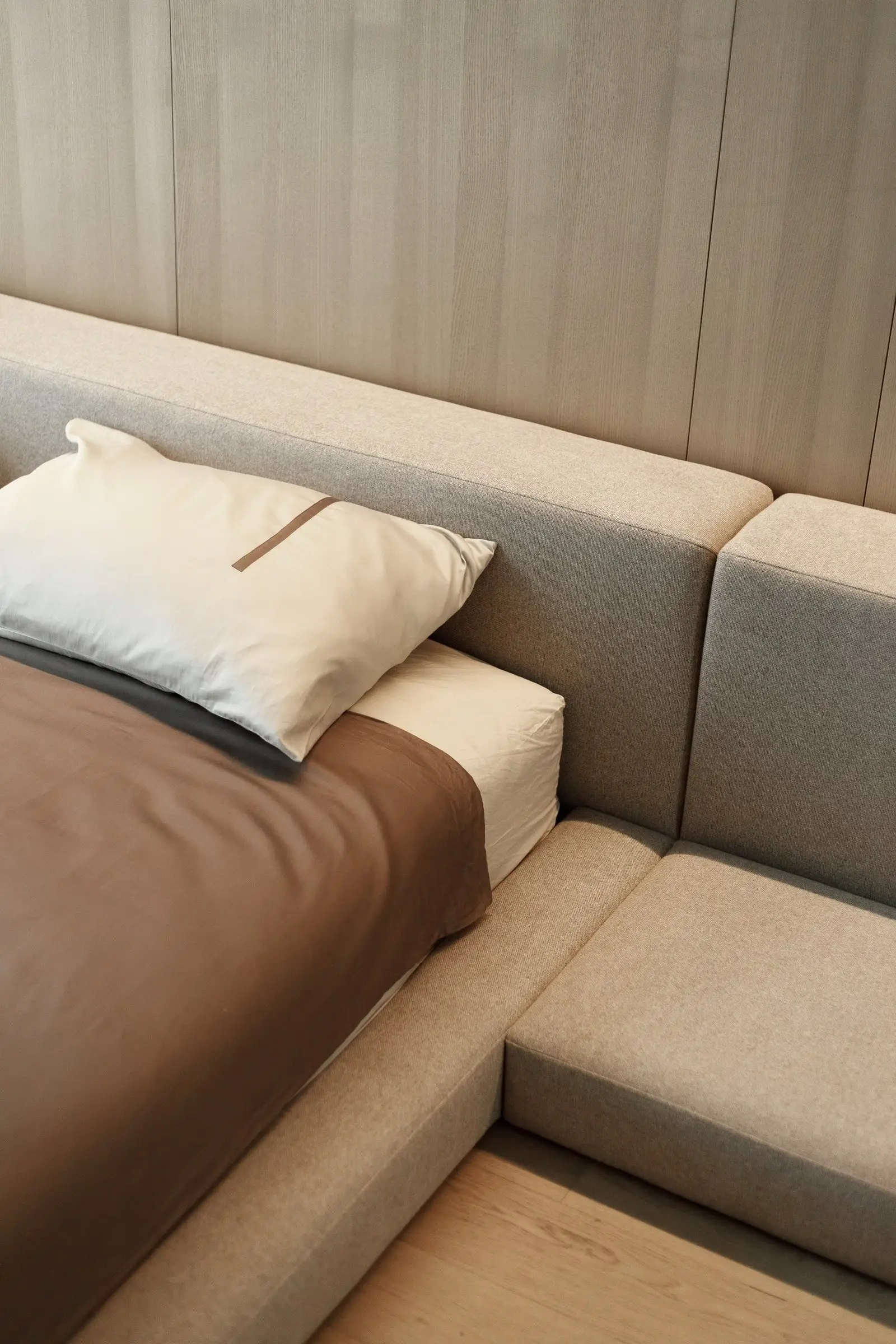 Three-quarter view of the Connect bench extension showing the cushion module meeting the bed body