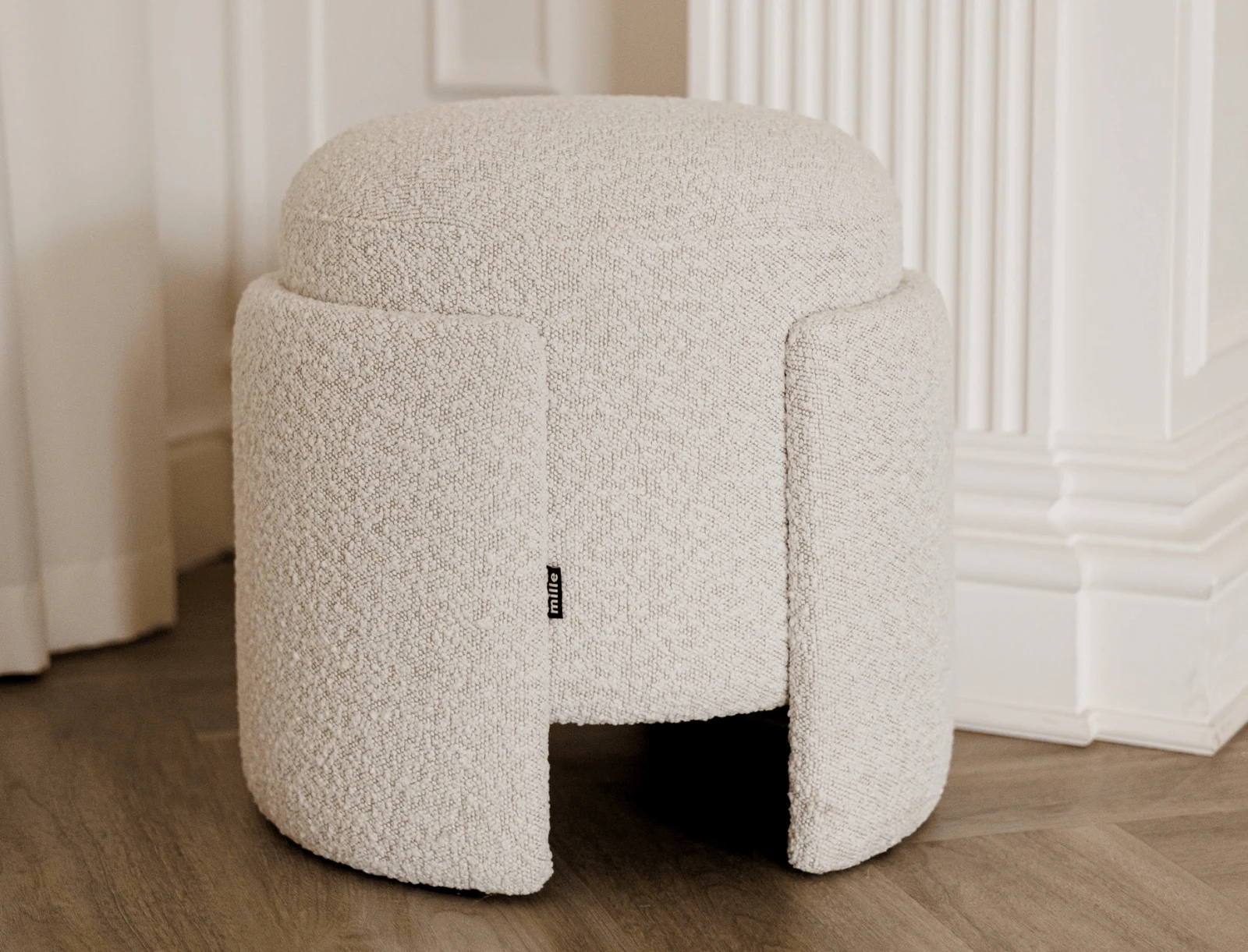 Studio render of the Eden pouf against a panelled wall