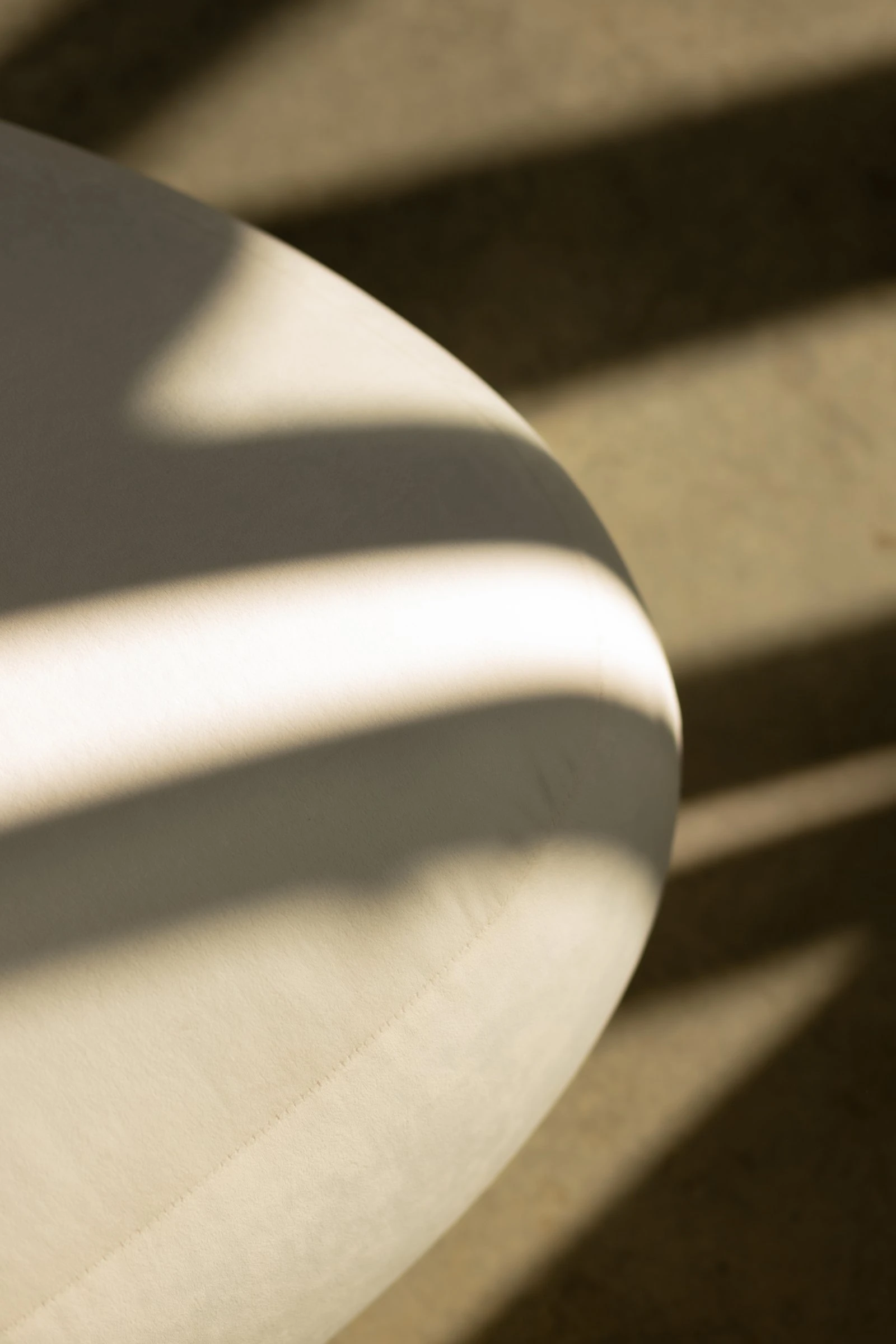Macro of the cream velvet Chios fabric with a stripe of light