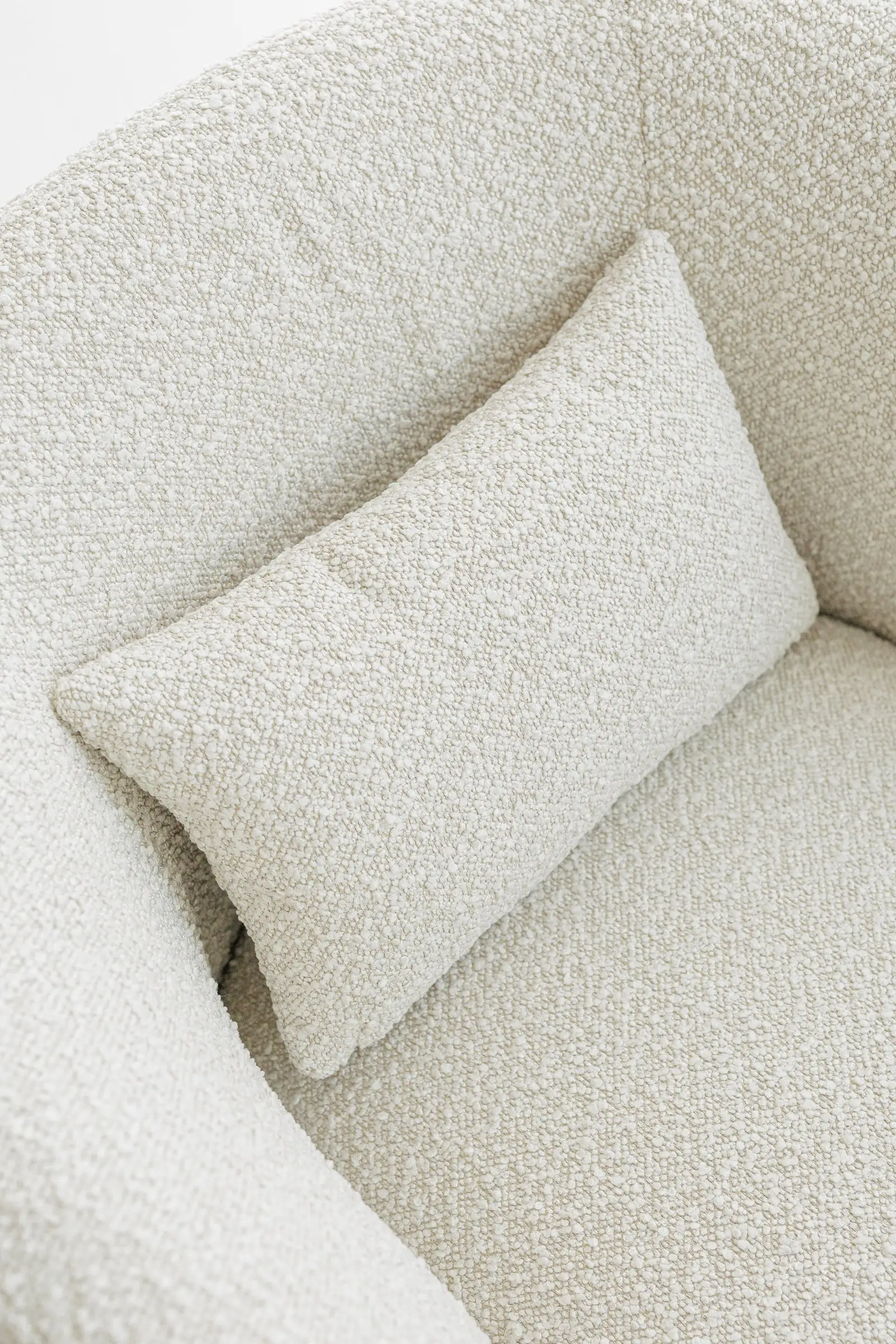 Close macro of the cream Santa Cruz 801 boucle fabric texture on the Nuba arm