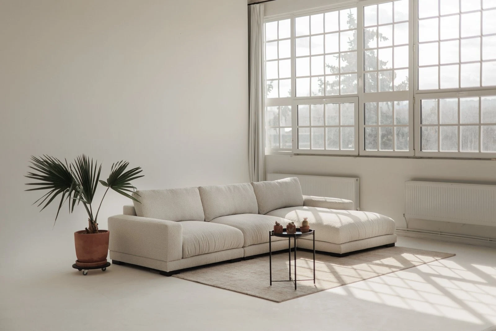 Close detail of cream boucle Palermo cushions and bolsters, soft texture