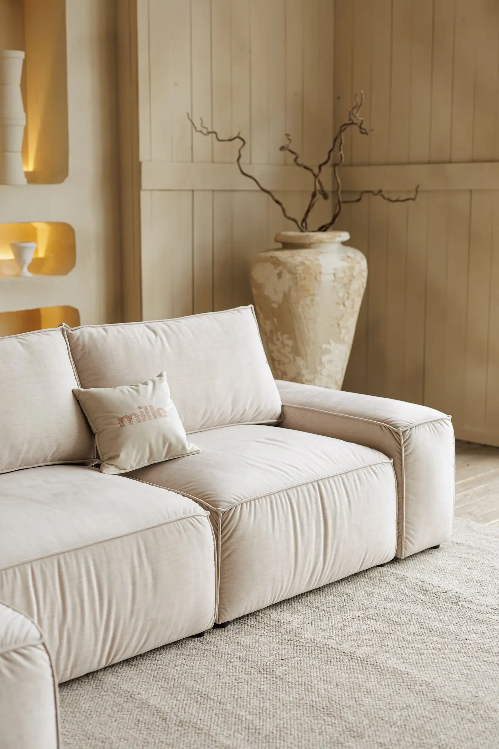 Cream Milano next to a beige boiserie wall with a sculptural plaster vase