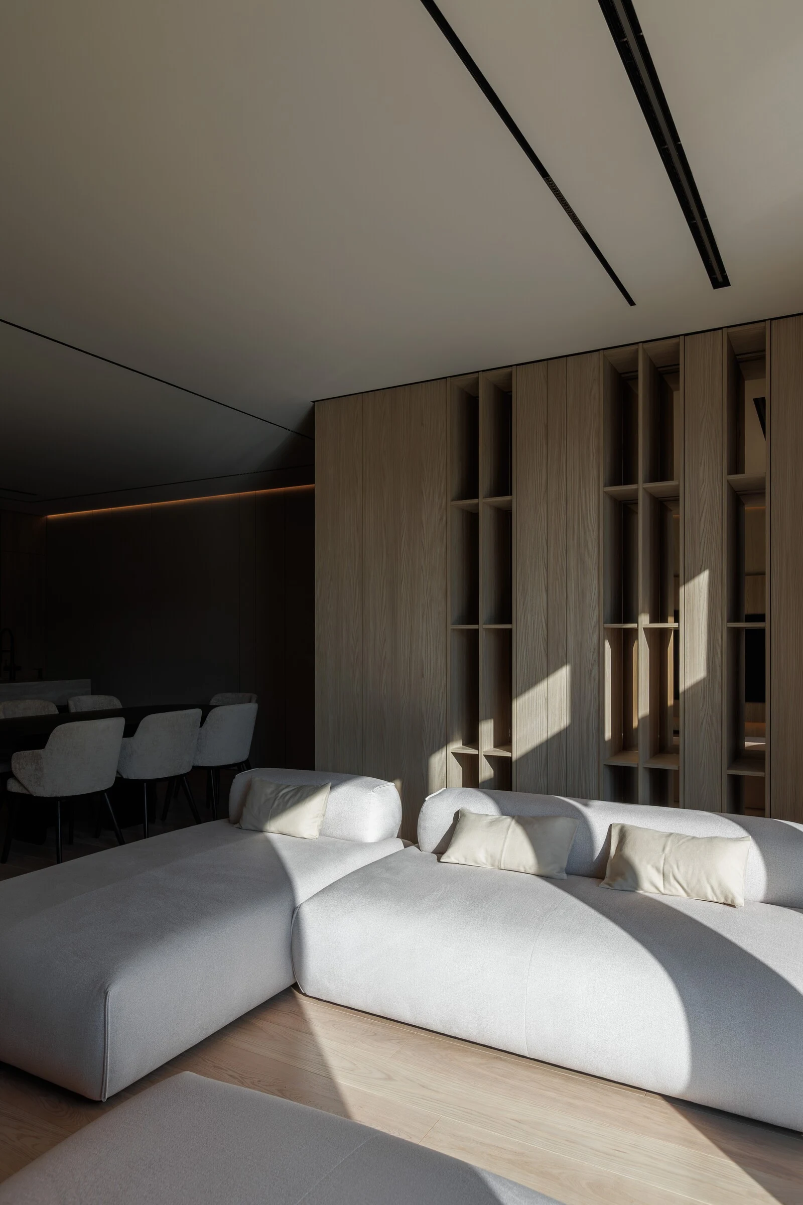 Cream Nissa in a sun-striped corner of an oak-panelled apartment, dramatic afternoon light