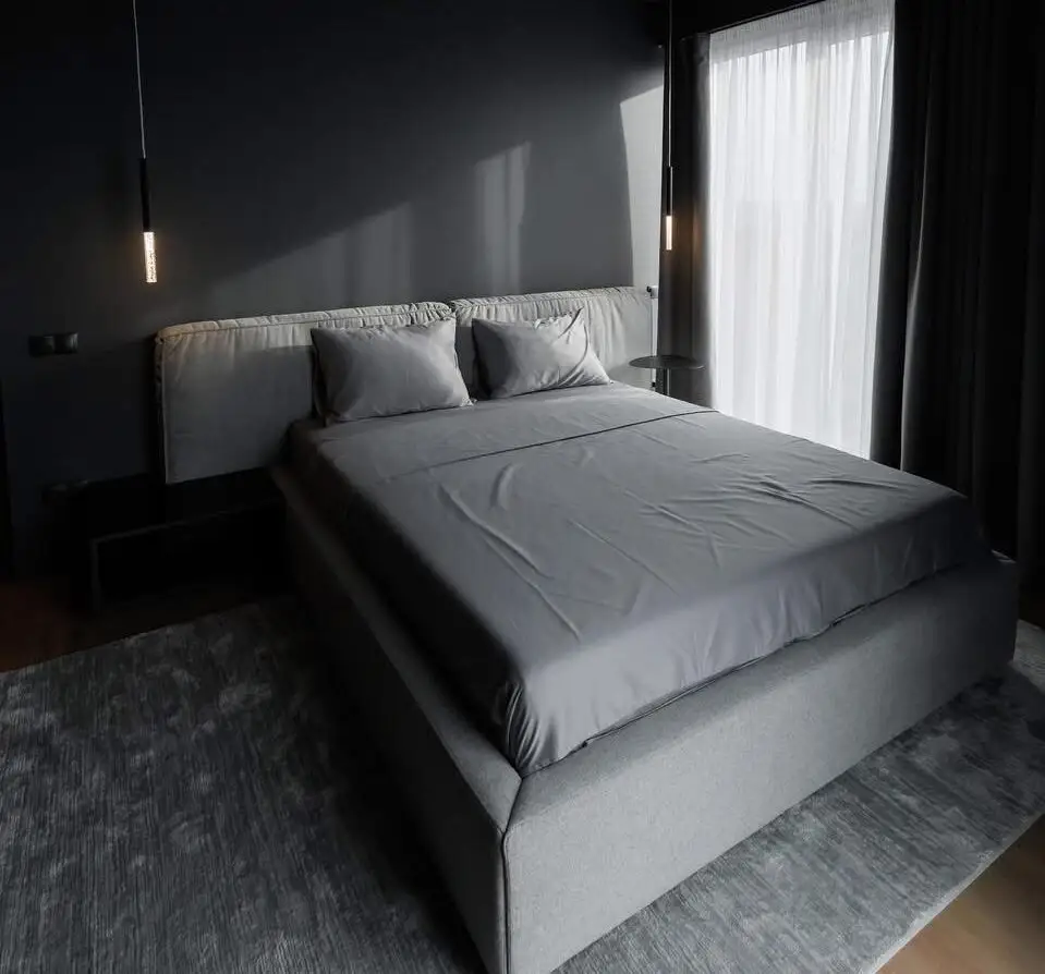 Mid-grey Palermo in a dark-walled bedroom with hanging tube pendants and a sheer curtain at the window