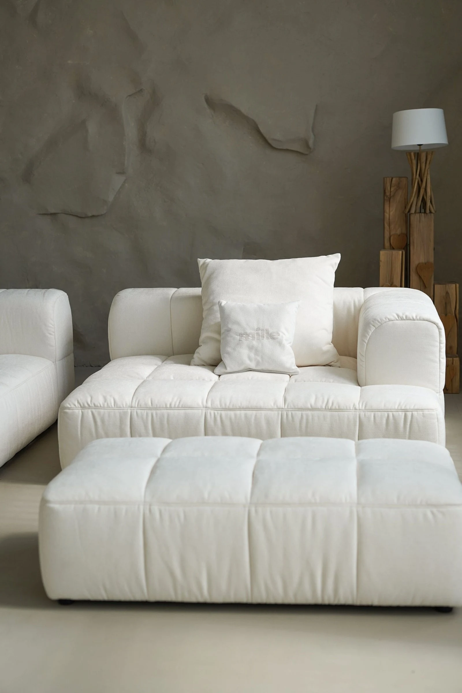 Cream Soft with driftwood lamp and a Mille pillow in a textured-plaster villa room