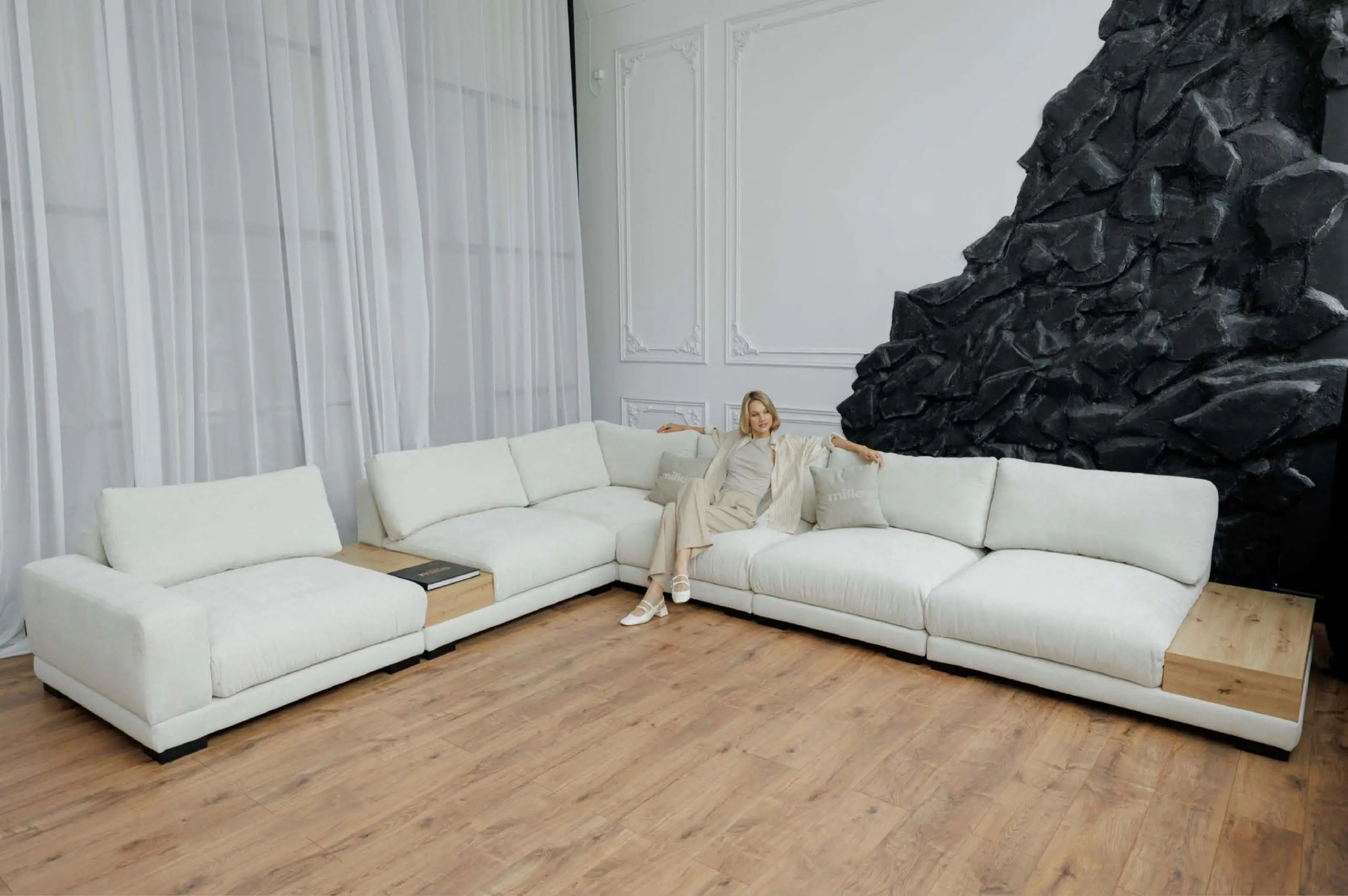 Ivory Kingston modules with low backs against a sculpted black feature wall.
