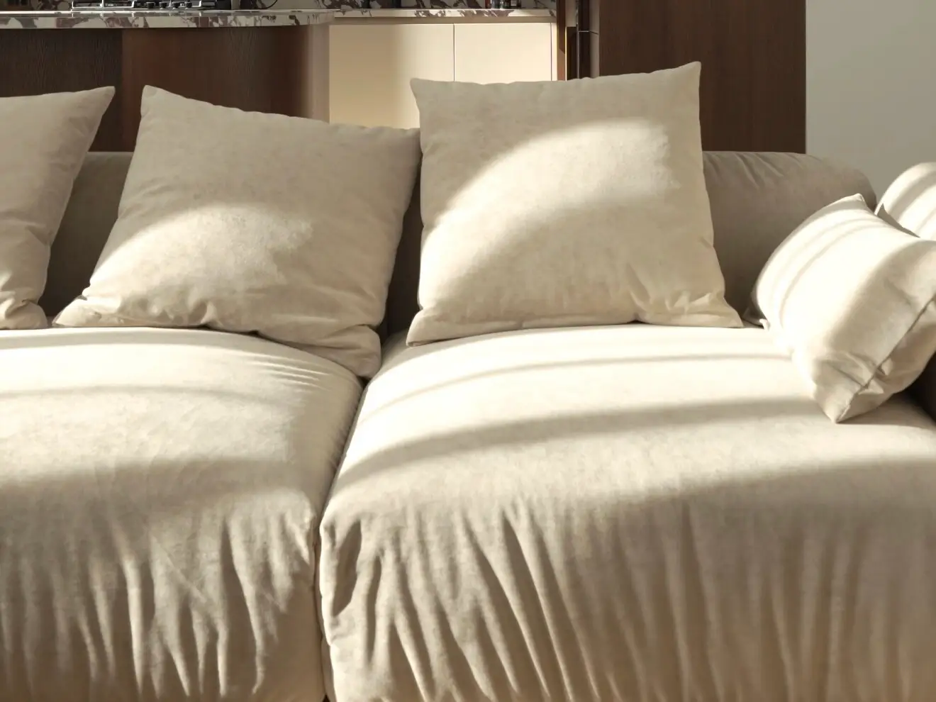 Close detail of cream velvet cushions in golden hour sunbeams