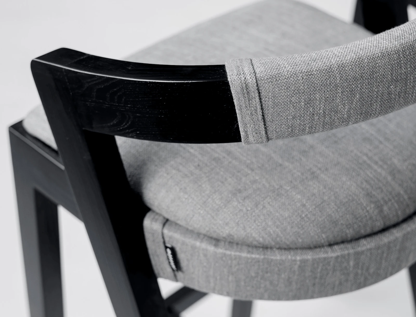 Close detail of the small Mille label sewn into the grey Antwerp 180018 seat of the Baffi bar stool