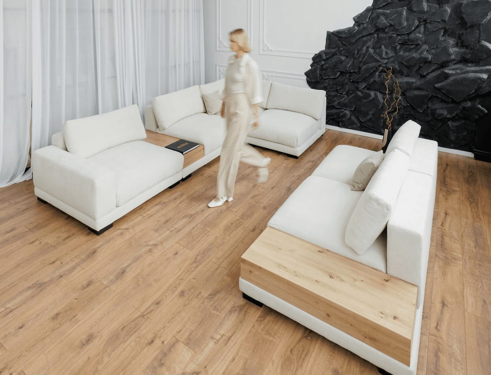 Two cream Palermos facing each other across an oak floor with a stone-art wall in the background